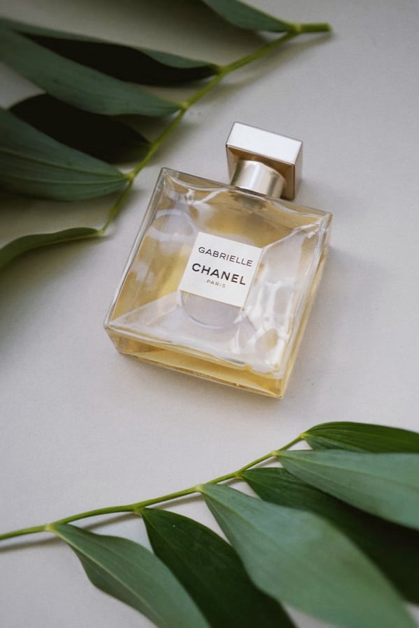 Picture of a perfume
          bottle with leaves on the side